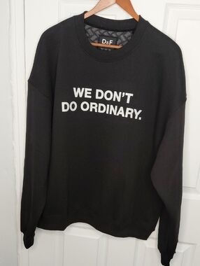 Men's Black Crewneck Sweater with 'WE DON'T DO ORDINARY.' Graphic